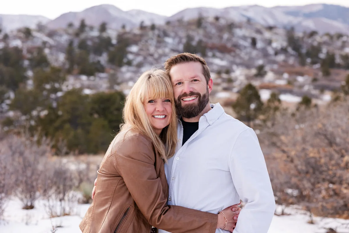 Laura and Matt Parker smiling together in the snowy Colorado mountains